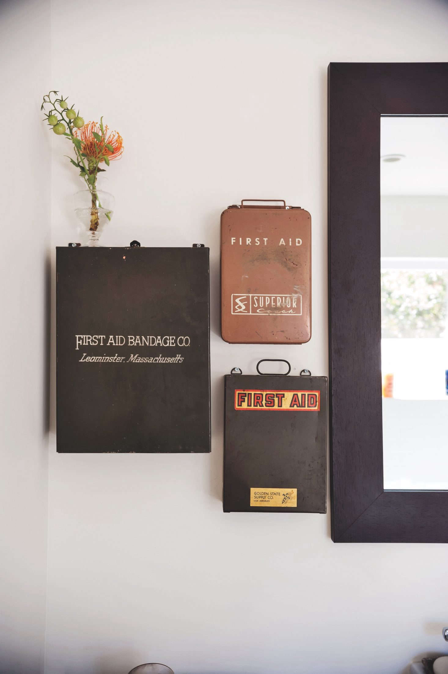 wall mounted vintage first aid boxes as improvised medicine cabinet